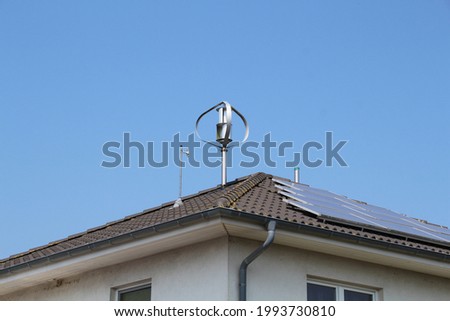 small wind turbine on house roof Royalty-Free Stock Photo #1993730810