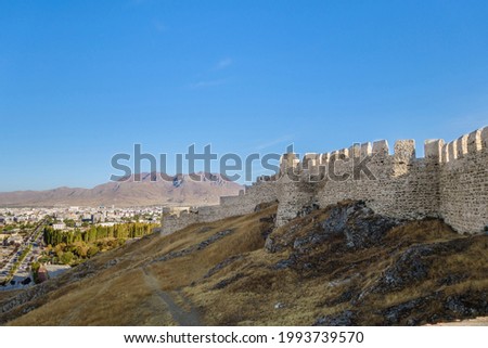 Massive fortifications of Van Fortress, Van, Turkey. It was founded in 9 century BC by Urartians and reinforced by Turks in medieval. Modern Van is on background
