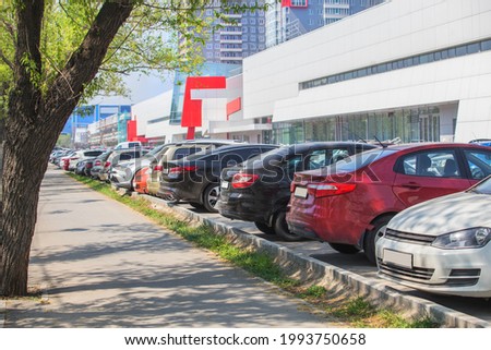 Cars in a parking lot near a shopping mall