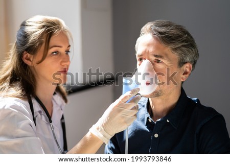 Asthma COPD Breath Nebulizer And Mask Given By Doctor Or Nurse Royalty-Free Stock Photo #1993793846