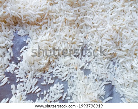 Beautiful fresh rice grains, seeds, kernels. Close up picture of dry rice. Pile of white rice before cooking. Healthy food. Natural food. Photo of rice product of Pakistan. Food concept background 