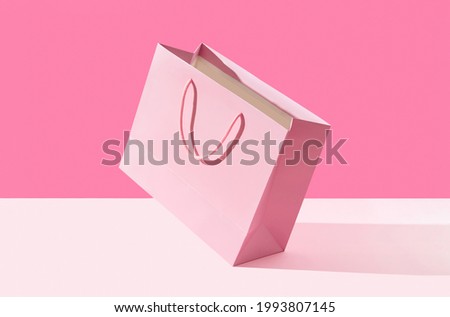 Paper shopping bag on pink background. Shopping sale delivery concept Royalty-Free Stock Photo #1993807145