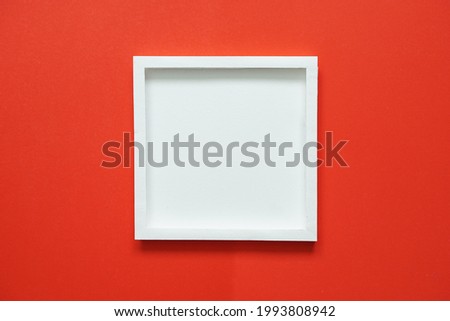 blank white square frame on red background.