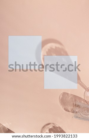 square business crad mockup on pink background with wineglass shadows and reflection