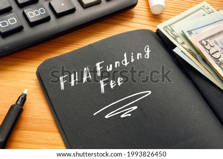 Financial concept meaning FHA Funding Fee with sign on the piece of paper. 
