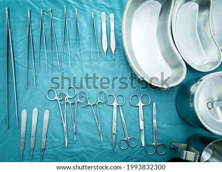 Different surgical instruments lying on the surgical table. Steel medical instruments ready to be used. Royalty-Free Stock Photo #1993832300