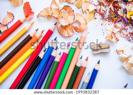 Sharpend crayons on a white background. Pencil shavings, different colors crayon pencil scrap. pencil peels. pencil sharpener Royalty-Free Stock Photo #1993832387