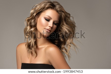Beautiful model girl with short hair .Beauty  smiling woman with blonde curly hairstyle dye .Fashion, cosmetics and makeup Royalty-Free Stock Photo #1993847453