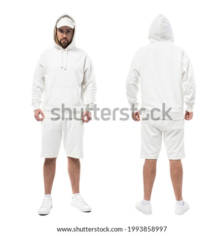Handsome man wearing blank white cap, hoodie and shorts isolated on white background
