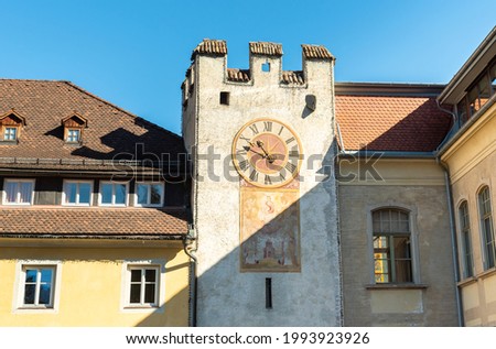 Tower with clock of Ursuline Gate in the historic city of Bruneck or Brunico, South Tyrol, Italy