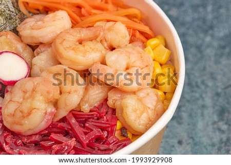 Close-up of shrimp poke with carrots, beets and seaweed.
