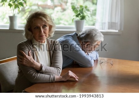 Pensive senior Caucasian woman and husband think of relationships problems, ignore each other after fight. Unhappy thoughtful old couple spouses avoid communication, think of divorce breakup. Royalty-Free Stock Photo #1993943813