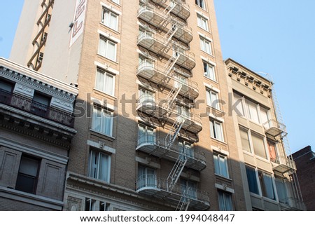 A well maintained external fire escape on a San Francisco building with rounded corners.