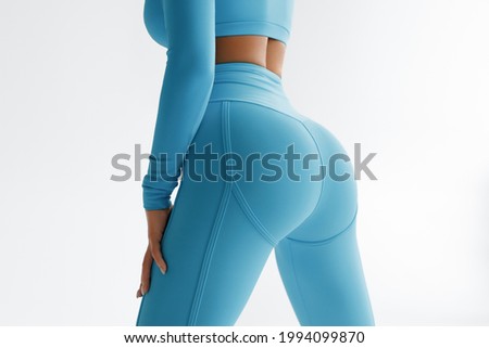 Fitness model in leggings with beautiful buttocks. Sporty booty Royalty-Free Stock Photo #1994099870