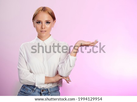 Young woman show open palm isolated on pink background