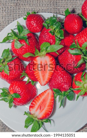 Fresh strawberries in a bowl on a textile background
