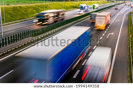 Trucks on six lane controlled-access highway in Poland.
 Royalty-Free Stock Photo #1994149358