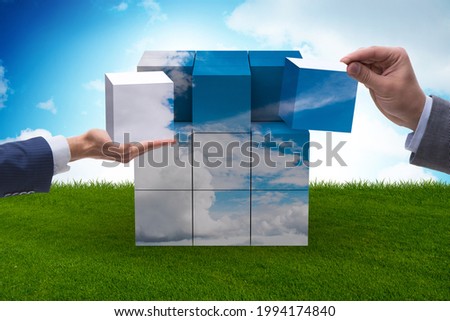 Businessman building cloud cube with shapes
