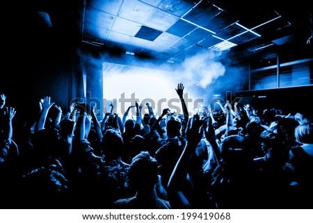 Nightclub party crowd with hands in the air Royalty-Free Stock Photo #199419068