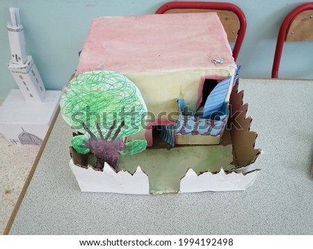 Paper mosque, paper house and shrubs created by young children using cardboard