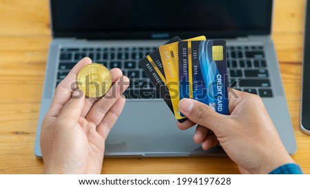 Businessman holding credit card and bitcoin to buy online bill on computer Contactless people pay in restaurants Smart Payment Concept Bank Person Person
