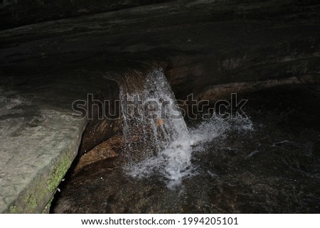 Closeup of  water falling over a small rock face