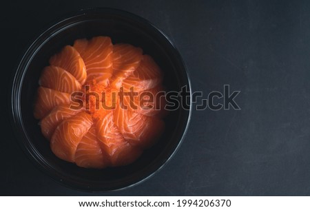 Salmon don delicious in Japanese buffet restaurant.Fresh salmon fillet in rice bowl.Asian people eating sashimi set  