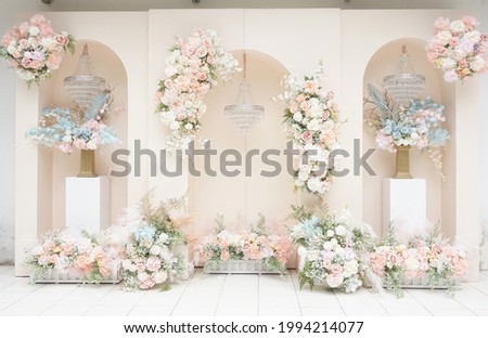 Santorini wedding backdrop in pastel pink with floral arrangements and decorations Royalty-Free Stock Photo #1994214077