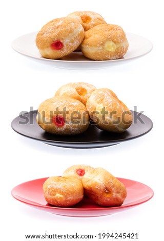 Collection of Jam filled doughnuts on plate isolated on white background. Royalty-Free Stock Photo #1994245421