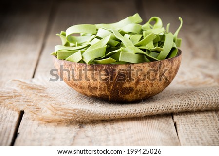 Spinach pasta on the wooden background, photo studio.