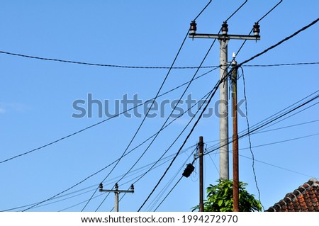 Electric cables and poles in residential areas of West Java, Indonesia Royalty-Free Stock Photo #1994272970