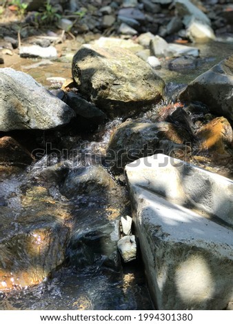 The water of mountain extremly Clear and flows through the rocks.I do consume this water while exploring the mountain.Besides clean and clear this also fresh. Beautiful scenary with a little sunshine.
