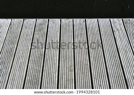 Close Up of Timber Decking on Pontoon beside Industrial Canal 