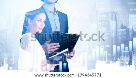 Office woman and man analysing business report on background of office buildings, New York city view. Double exposure with stock market chart. Concept of financial analysis