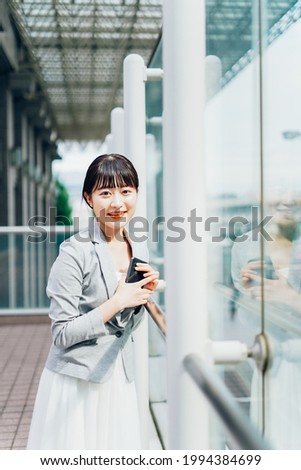 A young businesswoman waiting outside for a meeting