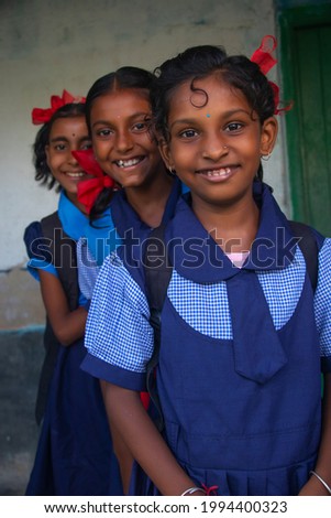 Smiling Three indian Rural School Girl wearing School Uniform Standing in school Royalty-Free Stock Photo #1994400323