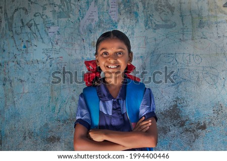 portrait of a rural school girl Smiling and standing in School Royalty-Free Stock Photo #1994400446