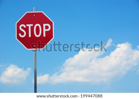 Stop sign for traffic against blue sky 