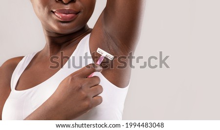 Closeup Of Unrecognizable African American Lady Shaving Underarm With Pink Razor, Black Woman Making Armpit Hair Removal, Standing Isolated Over Grey Background, Cropped Shot With Copy Space Royalty-Free Stock Photo #1994483048