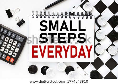 Small steps everyday . text on notepad on white background