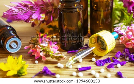 medicinal herbs, oils in small bottles homeopathy. selective focus.