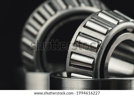 Two new car bearings on a black background macro photo
