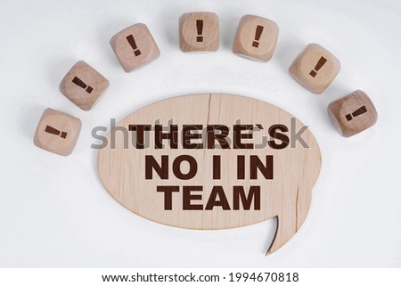 Business and finance concept. On a white background, cubes with an exclamation mark and a sign - thoughts with the inscription - THERE S NO I IN TEAM