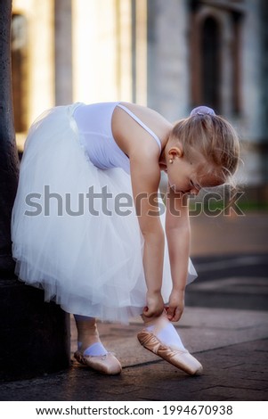 Little ballerina straightens pointe shoes 