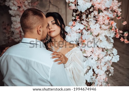 Husband and wife couple hugging sitting photo session studio. Wedding married bride and groom celebrate their engagement. Procreation romantic amazing lovers newlyweds indoor, copy space.
