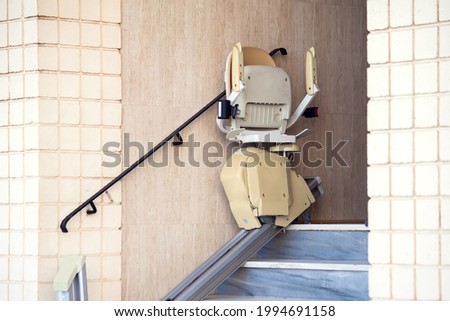 Stair elevator for disabled people. Chair lift Royalty-Free Stock Photo #1994691158