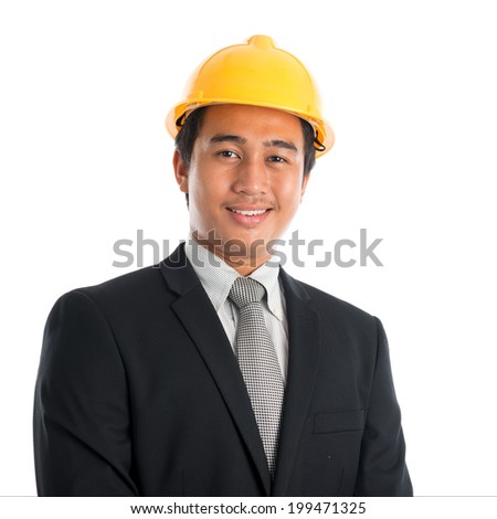 Close-up of an Asian young man wearing a hardhat smiling and looking at camera, standing isolated on white background.