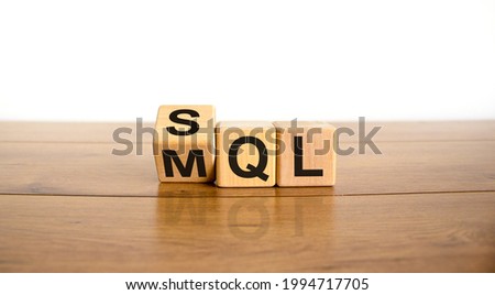 SQL or MQL symbol. Turned wooden cubes and changed words 'MQL marketing qualified lead' to 'SQL sales qualified lead'. Beautiful white background. Business and SQL or MQL concept. Copy space. Royalty-Free Stock Photo #1994717705
