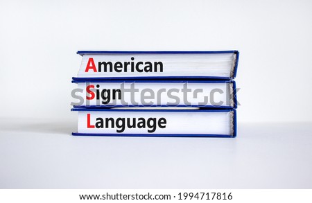 ASL, american sign language symbol. Books with words 'ASL, american sign language'. Beautiful white background. Medical and ASL, american sign language concept. Copy space.