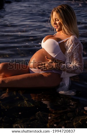
pregnant woman enjoying sea water at sunset
pregnancy concept